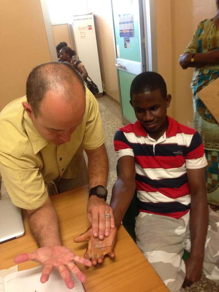 Hand surgeon with Patient in Ghana