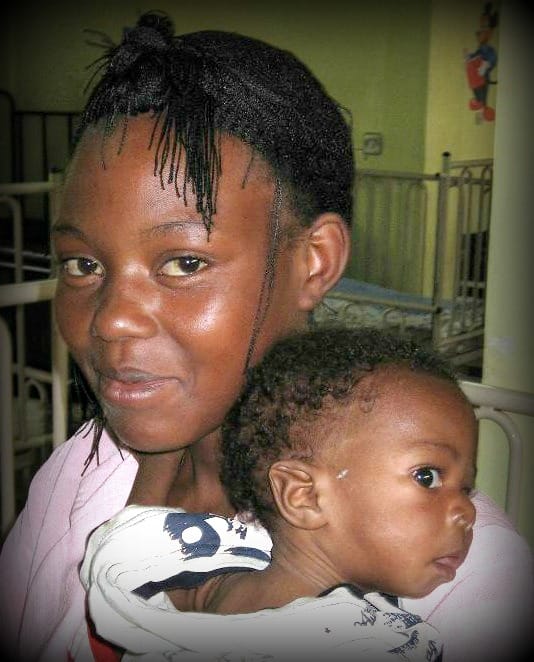 Uganda nurse with a child in the NICU